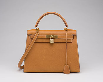 A VINTAGE GOLD CHÈVRE LEATHER SELLIER KELLY 28 WITH GOLD HARDWARE by  HERMÈS sold for $12,500