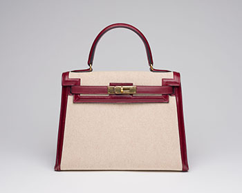 A VINTAGE TOILE AND ROUGE H BOX KELLY 28 SELLIER GOLD HARDWARE by  HERMÈS sold for $10,000
