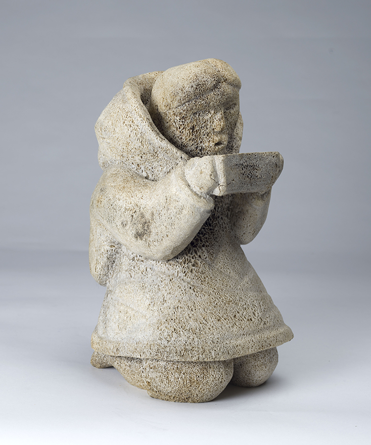 Kneeling Woman Holding a Qulliq by Unidentified Inuit Artist