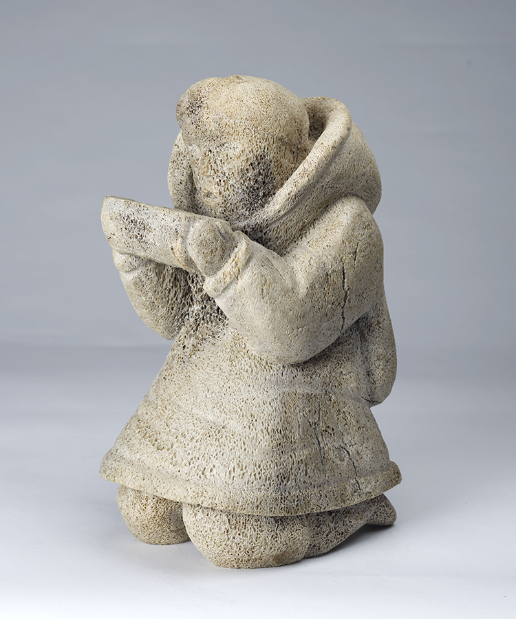 Kneeling Woman Holding a Qulliq by Unidentified Inuit Artist