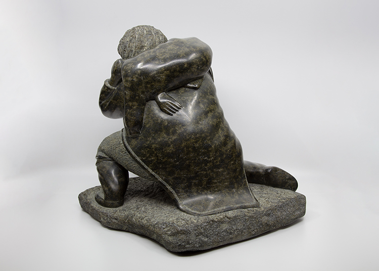 Kneeling Man Carrying Seal by Lucassie Ikkidluak